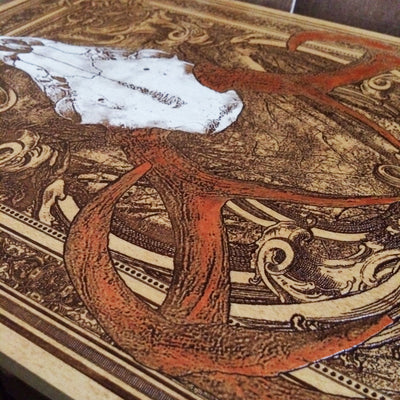 Deer skull carving on wood panel, bold wall art for hunters or collectors.