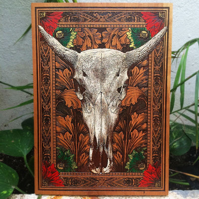 Laser-engraved cow skull wall art on natural cherrywood with rustic style.