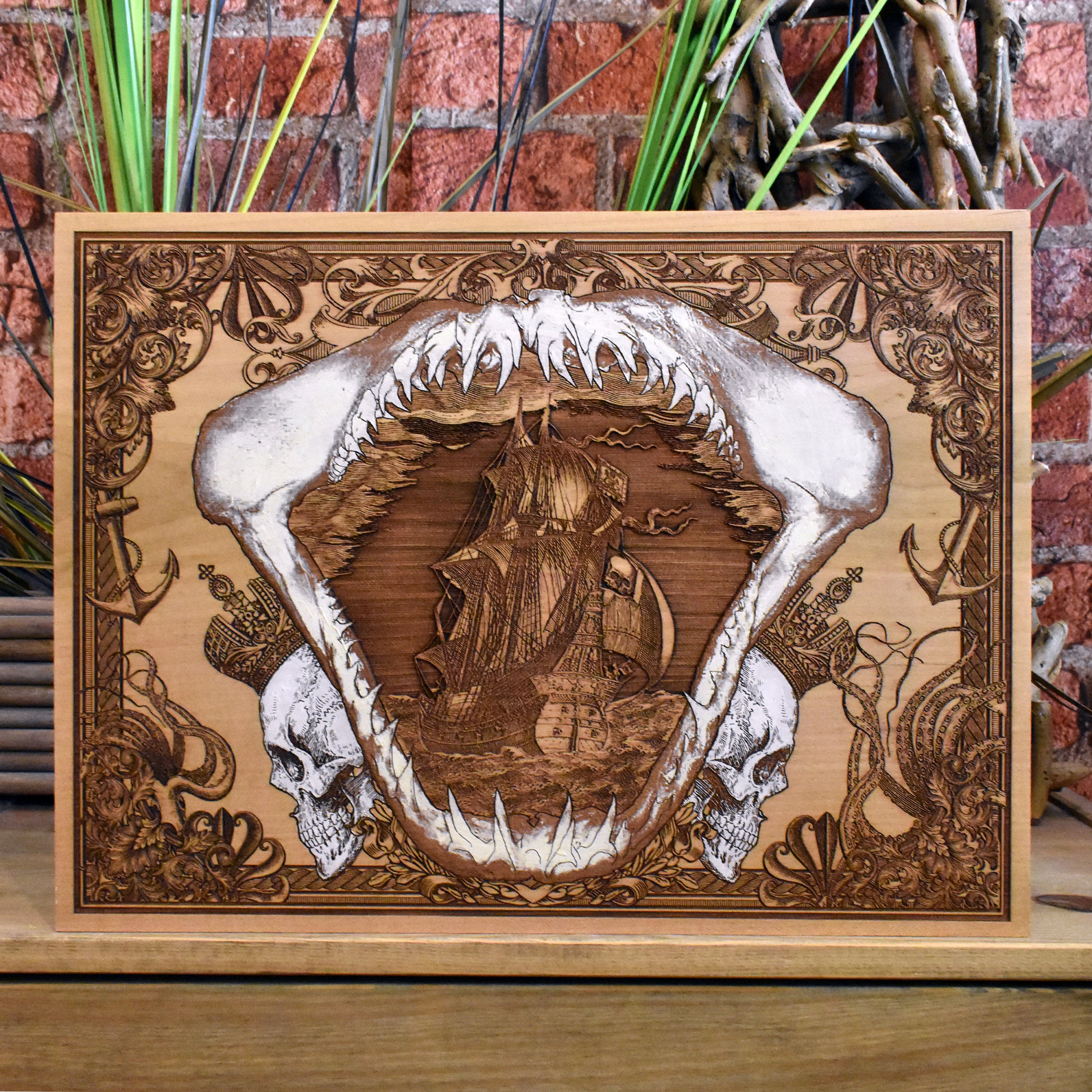 Engraved wood wall art with pirate ship inside shark jaw, nautical design