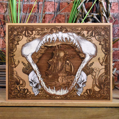 Engraved wood wall art with pirate ship inside shark jaw, nautical design