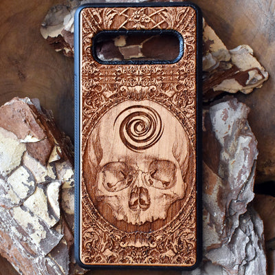 Wooden phone case with detailed skull carving, available for iPhone , iPhone 15, Galaxy S, S24, S23, Note 20, and more. A perfect gothic accessory with premium protection.