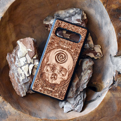 Wooden phone case with detailed skull carving, available for iPhone , iPhone 15, Galaxy S, S24, S23, Note 20, and more. A perfect gothic accessory with premium protection.