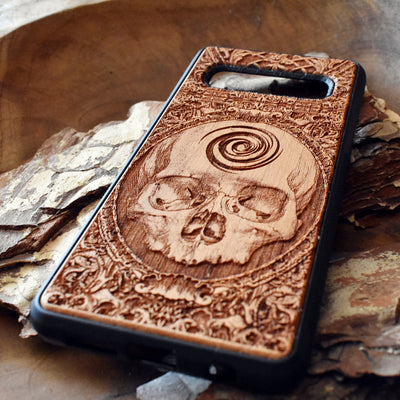 Wooden phone case with detailed skull carving, available for iPhone , iPhone 15, Galaxy S, S24, S23, Note 20, and more. A perfect gothic accessory with premium protection.