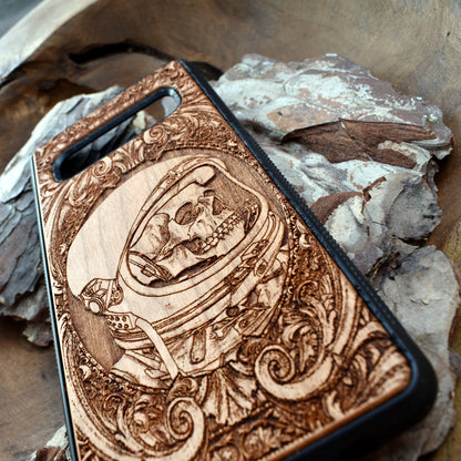 Wooden phone case with intricate engraved praying skeleton design, compatible with iPhone 16, iPhone 15, Samsung Galaxy S25, Note 20, and more. Perfect for gothic art lovers and unique phone accessories.