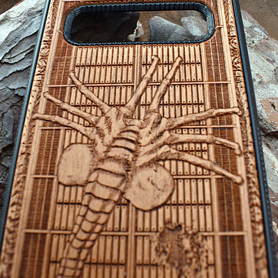 Alien Facehugger wooden phone case with detailed engraving, designed for iPhone , iPhone 15, Galaxy S, and other models. Perfect for sci-fi and horror fans looking for unique, durable protection.