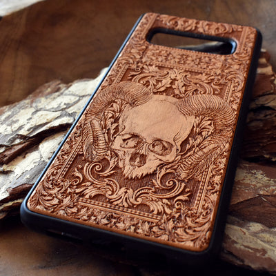 Skull and ram horns laser-engraved wooden phone case for iPhone & Samsung Galaxy – Compatible with iPhone  and Samsung Galaxy S

This optimization focuses on the dark, gothic, and alternative elements of the design, including the skull and ram horns theme, while also highlighting the compatibility with both iPhone and Samsung Galaxy models for better search engine visibility.