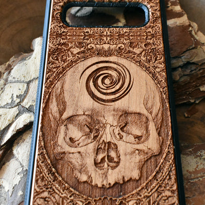 Wooden phone case with detailed skull carving, available for iPhone , iPhone 15, Galaxy S, S24, S23, Note 20, and more. A perfect gothic accessory with premium protection.