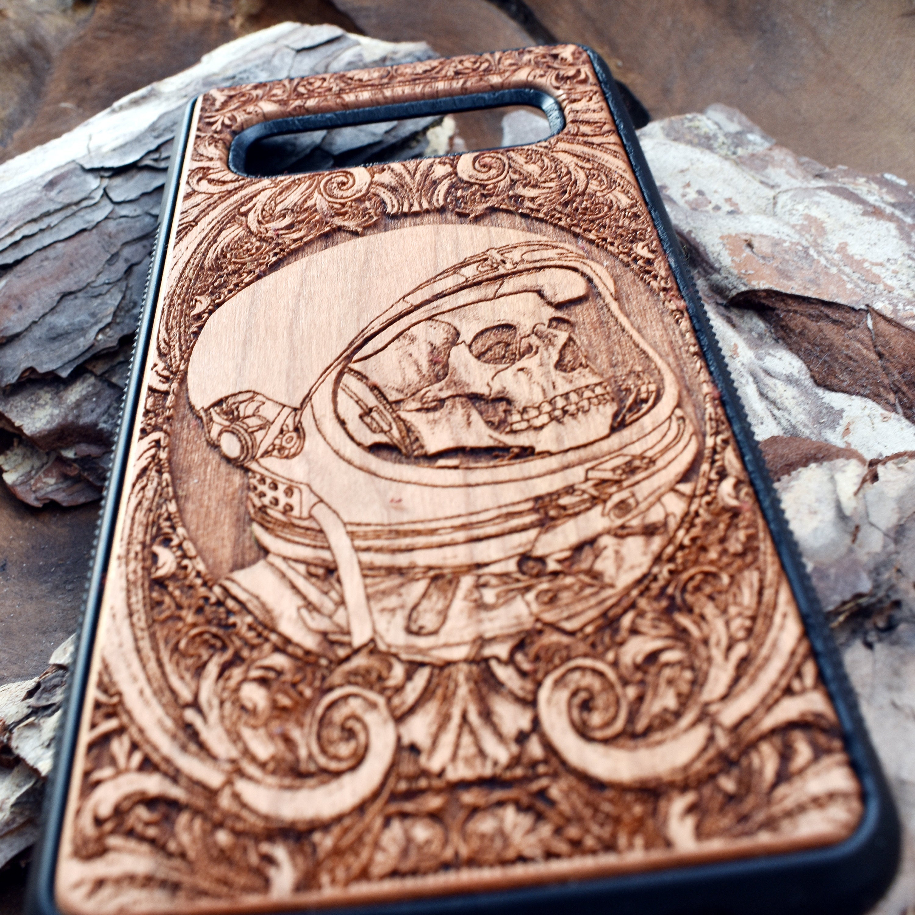 Wooden phone case with intricate engraved praying skeleton design, compatible with iPhone 16, iPhone 15, Samsung Galaxy S25, Note 20, and more. Perfect for gothic art lovers and unique phone accessories.