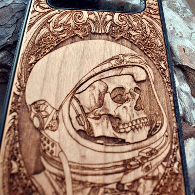 Wooden phone case with intricate engraved praying skeleton design, compatible with iPhone , iPhone 15, Samsung Galaxy S, Note 20, and more. Perfect for gothic art lovers and unique phone accessories.