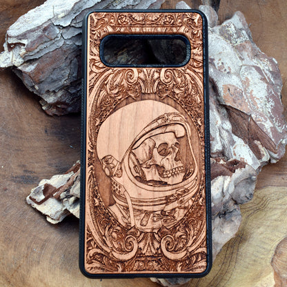 Wooden phone case with intricate engraved praying skeleton design, compatible with iPhone 16, iPhone 15, Samsung Galaxy S25, Note 20, and more. Perfect for gothic art lovers and unique phone accessories.