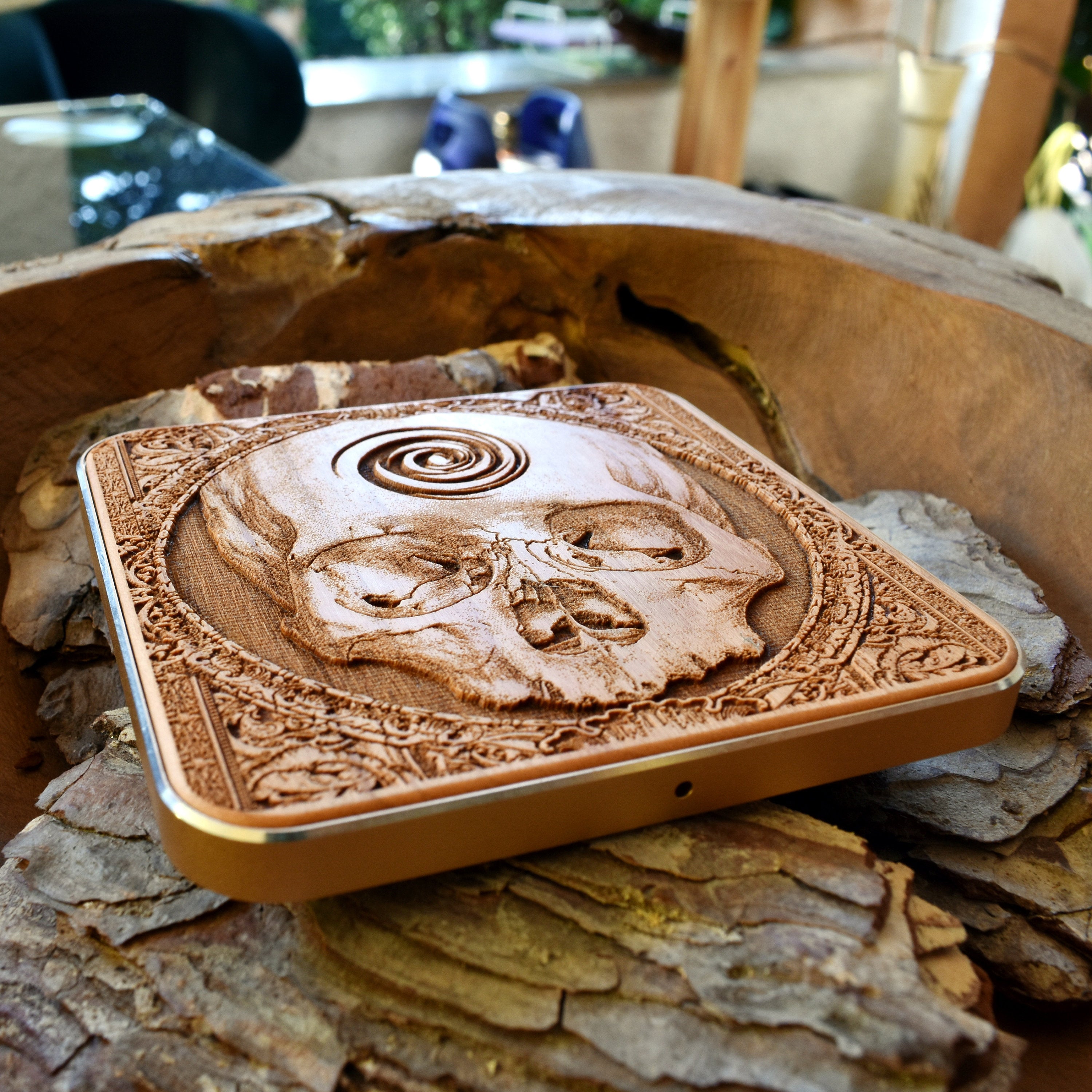 Handmade dark wood wireless charging pad featuring skull horror art, perfect gift for alternative style fans using Galaxy S25 or iPhone 16.