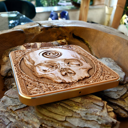 Handmade dark wood wireless charging pad featuring skull horror art, perfect gift for alternative style fans using Galaxy S25 or iPhone 16.