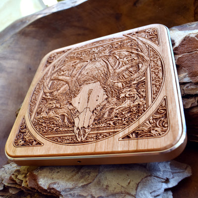 Overhead view of deer skull engraved charging pad adding dark art to any desk.