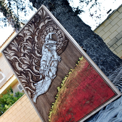 Unique wooden astronaut painting, cosmic space-themed artwork.