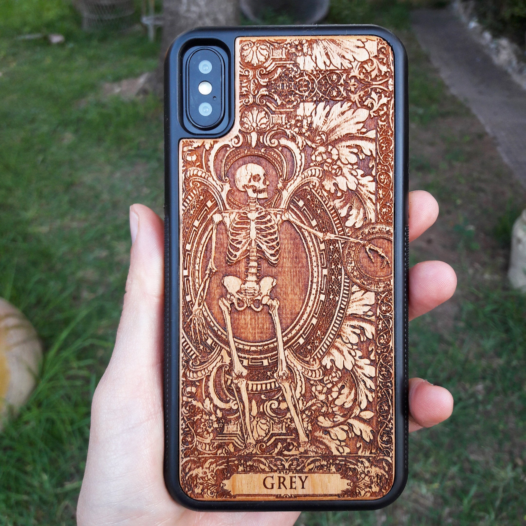 Personalized wood phone case featuring a skeleton design with custom names "Michelle" and "Jannik," ideal for iPhone 16 and Samsung Galaxy S25 users looking for unique and durable phone protection.