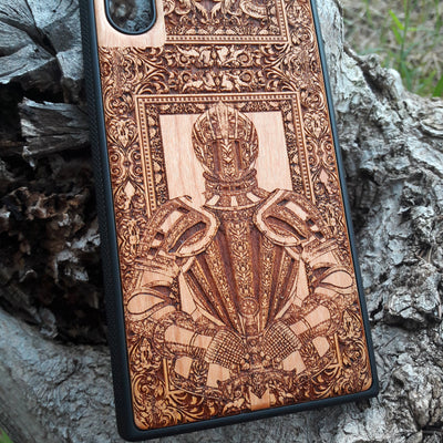 Wooden phone case featuring a detailed engraving of a medieval knight's armor, framed by intricate gothic designs. Ideal for iPhone , iPhone 15, iPhone 14, iPhone 13, Samsung Galaxy S, S24, S23, S22, and more. Perfect for lovers of history, knights, and medieval or gothic themes. Provides excellent protection while showcasing a unique, artistic design.