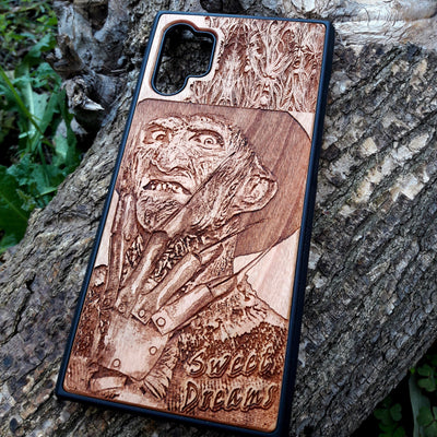Freddy Krueger wood phone case with a laser-engraved design, showing Freddy's menacing face and "Sweet Dreams" inscription. Compatible with iPhone  and Samsung Galaxy S, the case features a detailed, horror-themed engraving perfect for fans of A Nightmare on Elm Street.