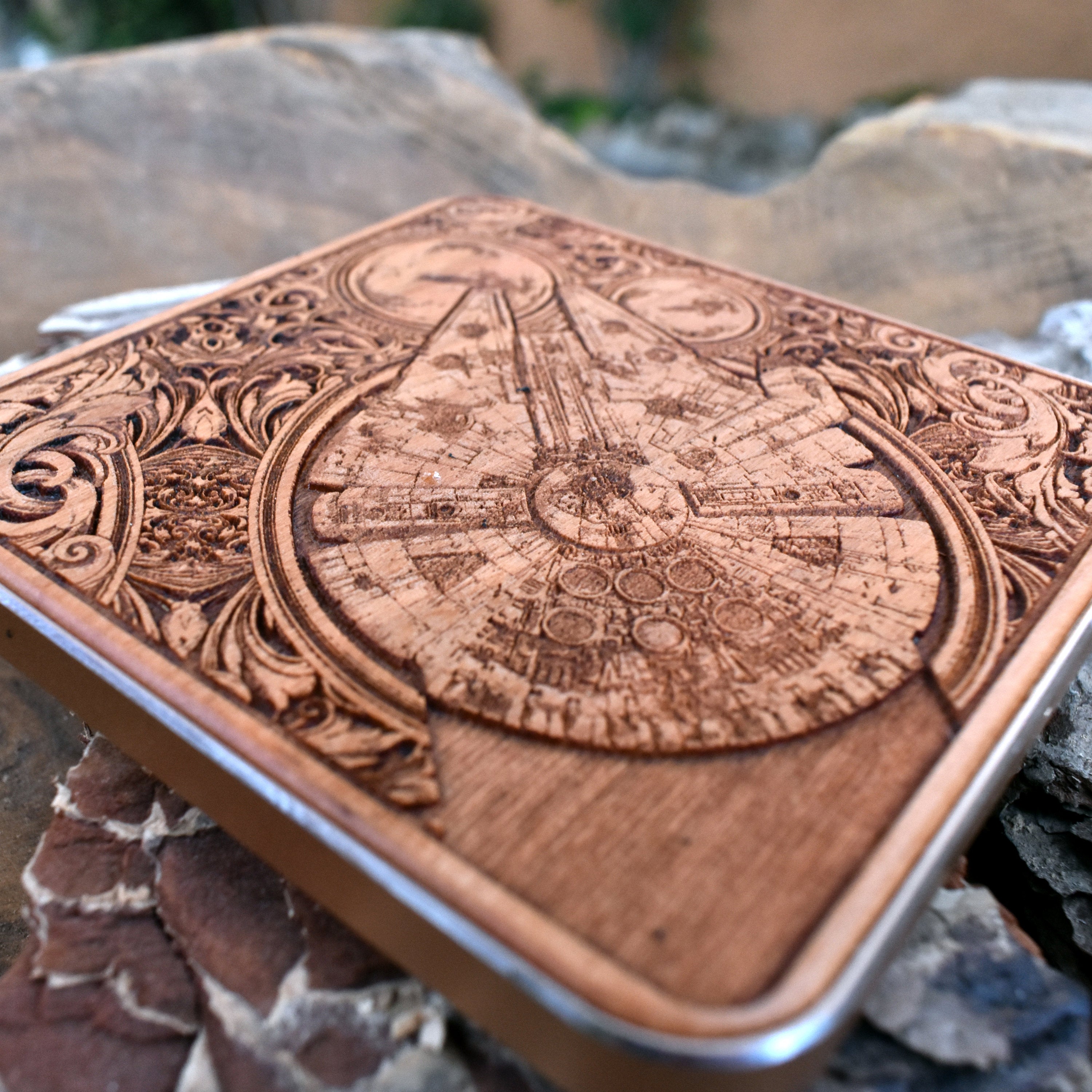 Close-up of detailed sci-fi ship engraving on wooden charging pad.