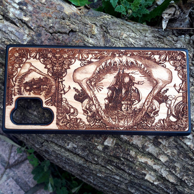 Wooden phone case with an intricate marine shark mandible design, featuring a detailed shipwreck and nautical elements. Laser-engraved on high-quality wood, this case is compatible with iPhone , iPhone 15, Samsung Galaxy S, S24, and more. Perfect for ocean lovers and those seeking a unique, eco-friendly accessory.