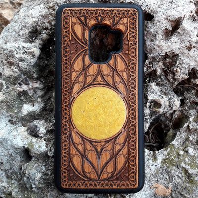 Laser-engraved wooden phone case featuring a detailed skull design, compatible with iPhone 16, iPhone 15, Galaxy S25, and more.