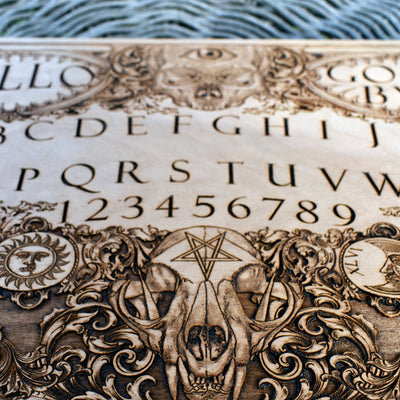 Engraved wooden Ouija board with intricate spirit board details.