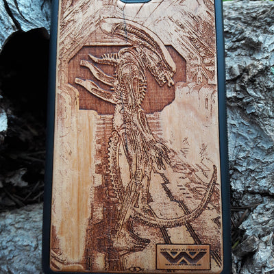 Wooden Xenomorph phone case with intricate HR Giger-inspired design, compatible with iPhone , iPhone 15, Galaxy S, and more. Perfect for Alien movie fans and sci-fi lovers.