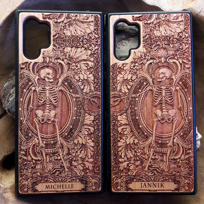 Personalized wood phone case featuring a skeleton design with custom names "Michelle" and "Jannik," ideal for iPhone 16 and Samsung Galaxy S25 users looking for unique and durable phone protection.