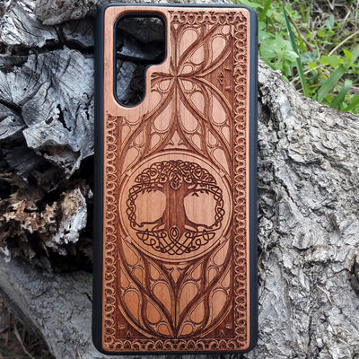 Wood phone case featuring a laser-engraved Tree of Life design surrounded by intricate Celtic-inspired patterns. Durable and stylish, this case is compatible with iPhone , 15, 14, 13, 12, 11, Pro Max, Mini, and Samsung Galaxy S, S24, S23, S22, S21, S20 Ultra, Plus, Note 20. A perfect accessory for nature lovers and fans of Celtic art.