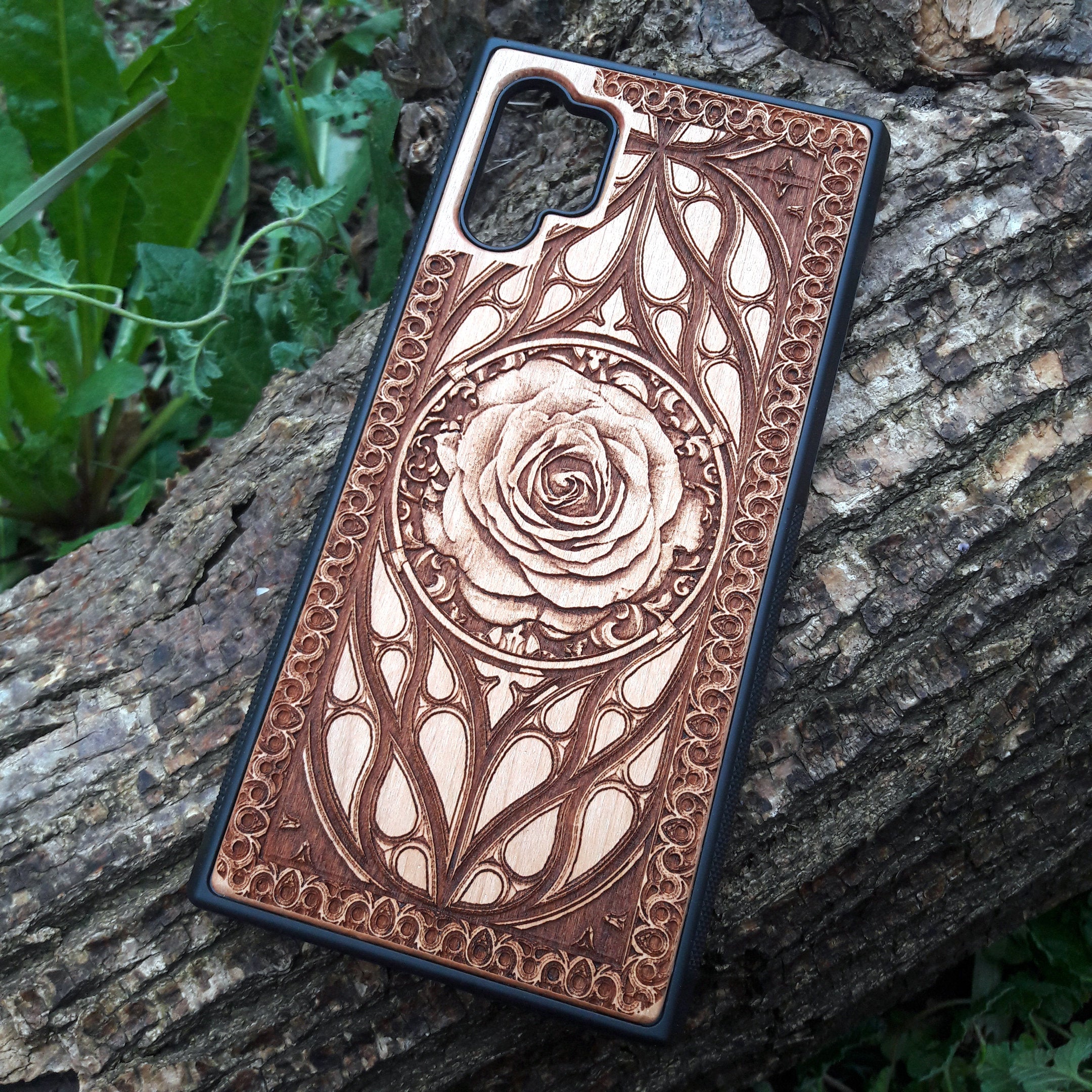 Laser-engraved wooden phone case with intricate rose design, slim, durable, and compatible with iPhone 16, iPhone 15, iPhone 14, iPhone 13, iPhone 12, iPhone 11, iPhone 16 Pro Max, iPhone 16 Mini, Samsung Galaxy S25, Samsung Galaxy S24, Samsung Galaxy S23, Samsung Galaxy S22, Samsung Galaxy S21, Samsung Galaxy S20 Ultra, Samsung Galaxy S20 Plus, and Samsung Galaxy Note 20. Nature-inspired and unique!
