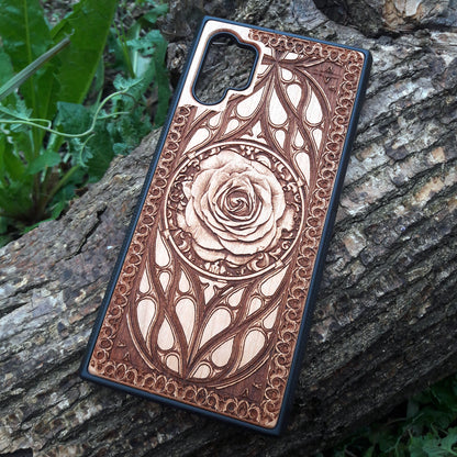 Laser-engraved wooden phone case with intricate rose design, slim, durable, and compatible with iPhone 16, iPhone 15, iPhone 14, iPhone 13, iPhone 12, iPhone 11, iPhone 16 Pro Max, iPhone 16 Mini, Samsung Galaxy S25, Samsung Galaxy S24, Samsung Galaxy S23, Samsung Galaxy S22, Samsung Galaxy S21, Samsung Galaxy S20 Ultra, Samsung Galaxy S20 Plus, and Samsung Galaxy Note 20. Nature-inspired and unique!