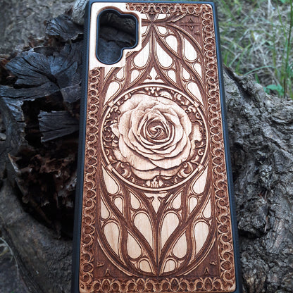 Laser-engraved wooden phone case with intricate rose design, slim, durable, and compatible with iPhone 16, iPhone 15, iPhone 14, iPhone 13, iPhone 12, iPhone 11, iPhone 16 Pro Max, iPhone 16 Mini, Samsung Galaxy S25, Samsung Galaxy S24, Samsung Galaxy S23, Samsung Galaxy S22, Samsung Galaxy S21, Samsung Galaxy S20 Ultra, Samsung Galaxy S20 Plus, and Samsung Galaxy Note 20. Nature-inspired and unique!