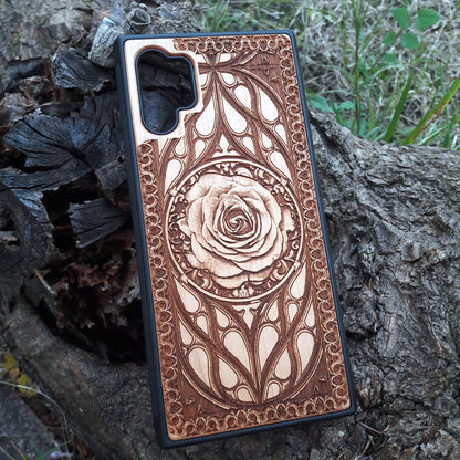 Laser-engraved wooden phone case with intricate rose design, slim, durable, and compatible with iPhone 16, iPhone 15, iPhone 14, iPhone 13, iPhone 12, iPhone 11, iPhone 16 Pro Max, iPhone 16 Mini, Samsung Galaxy S25, Samsung Galaxy S24, Samsung Galaxy S23, Samsung Galaxy S22, Samsung Galaxy S21, Samsung Galaxy S20 Ultra, Samsung Galaxy S20 Plus, and Samsung Galaxy Note 20. Nature-inspired and unique!