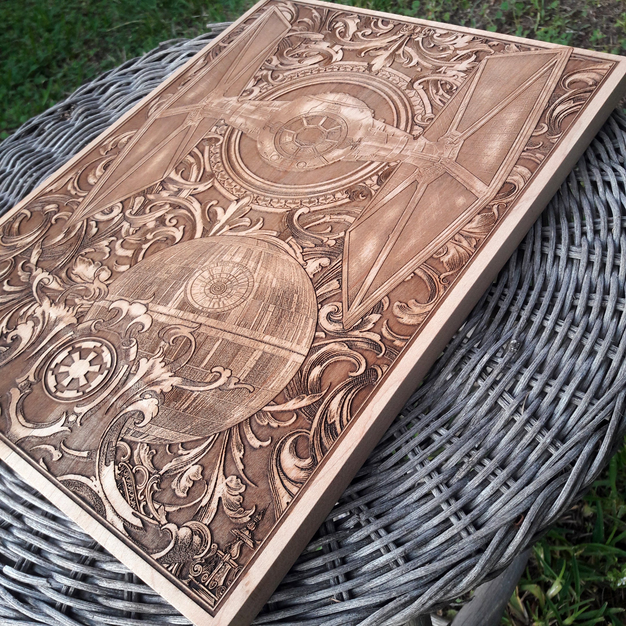 Handcrafted wood wall art of TIE Fighter spaceship, engraved detail.