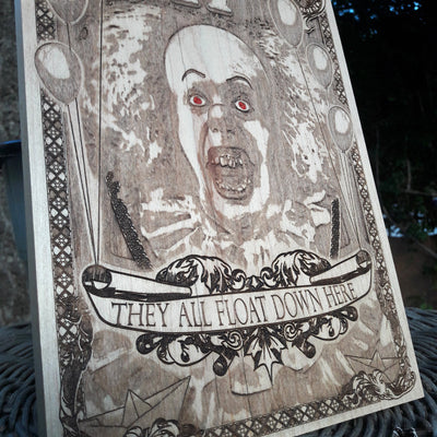 Horror-themed wood wall art of Pennywise the clown, perfect for Halloween.