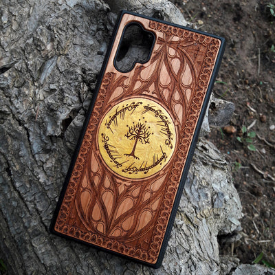 Hand-painted Lord of the Rings White Tree of Gondor wood phone case, featuring laser-engraved Elvish script and intricate designs with a golden accent. This durable and artistic case is compatible with iPhone , 15, 14, 13, 12, 11, Pro Max, Mini, and Samsung Galaxy S, S24, S23, S22, S21, S20 Ultra, Plus, Note 20. Perfect for Tolkien fans seeking a unique, elegant, and protective accessory.
