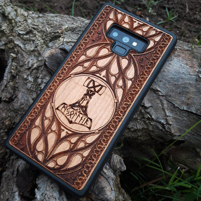 Eco friendly wood phone case carved with a beautiful carved Mjolnir the Hammer of Thor design. Quality sustainable wooden handcrafted and laser engraved covers.Available for: iPhone 11,12,13,14 Pro Max, Mini, Plus and Samsung Galaxy S20, S21, S22, Plus, Ultra, Note 20, Note 10