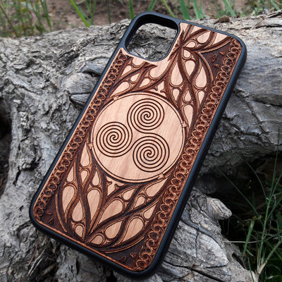 Wooden phone case with a Triskelion Celtic design laser-engraved in a circular pattern, featuring intricate Gothic detailing around the edges. Compatible with iPhone , 15, 14, 13, 12, 11 Pro Max Mini, and Samsung Galaxy S, S24, S23, S22, S21, S20 Ultra Plus, and Note 20. Durable and slim—ideal for lovers of Celtic symbols and unique handcrafted designs.