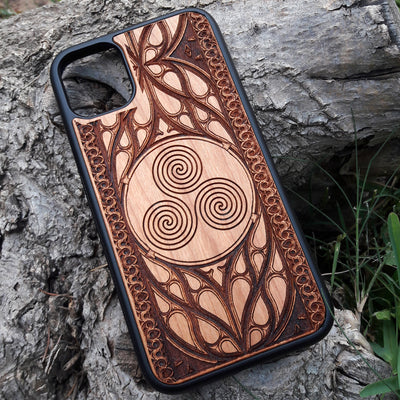 Wooden phone case with a Triskelion Celtic design laser-engraved in a circular pattern, featuring intricate Gothic detailing around the edges. Compatible with iPhone , 15, 14, 13, 12, 11 Pro Max Mini, and Samsung Galaxy S, S24, S23, S22, S21, S20 Ultra Plus, and Note 20. Durable and slim—ideal for lovers of Celtic symbols and unique handcrafted designs.
