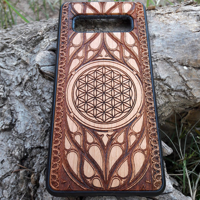 Wooden phone case featuring an intricate laser-engraved Flower of Life design, surrounded by detailed Gothic patterns. Slim, durable, and compatible with iPhone , 15, 14, 13, 12, 11 Pro Max Mini, and Samsung Galaxy S, S24, S23, S22, S21, S20 Ultra Plus, and Note 20. Perfect for those who love sacred geometry and unique craftsmanship.