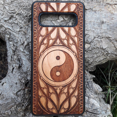 Wooden phone case with a laser-engraved Yin Yang symbol surrounded by a detailed Gothic pattern. Slim, durable, and designed for iPhone , 15, 14, 13, 12, 11 Pro Max Mini and Samsung Galaxy S, S24, S23, S22, S21, S20 Ultra Plus, Note 20. Ideal for those who appreciate balance and spiritual symbols in their phone accessories.