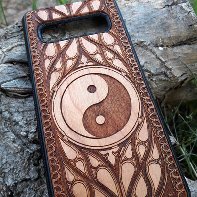 Wooden phone case with a laser-engraved Yin Yang symbol surrounded by a detailed Gothic pattern. Slim, durable, and designed for iPhone , 15, 14, 13, 12, 11 Pro Max Mini and Samsung Galaxy S, S24, S23, S22, S21, S20 Ultra Plus, Note 20. Ideal for those who appreciate balance and spiritual symbols in their phone accessories.