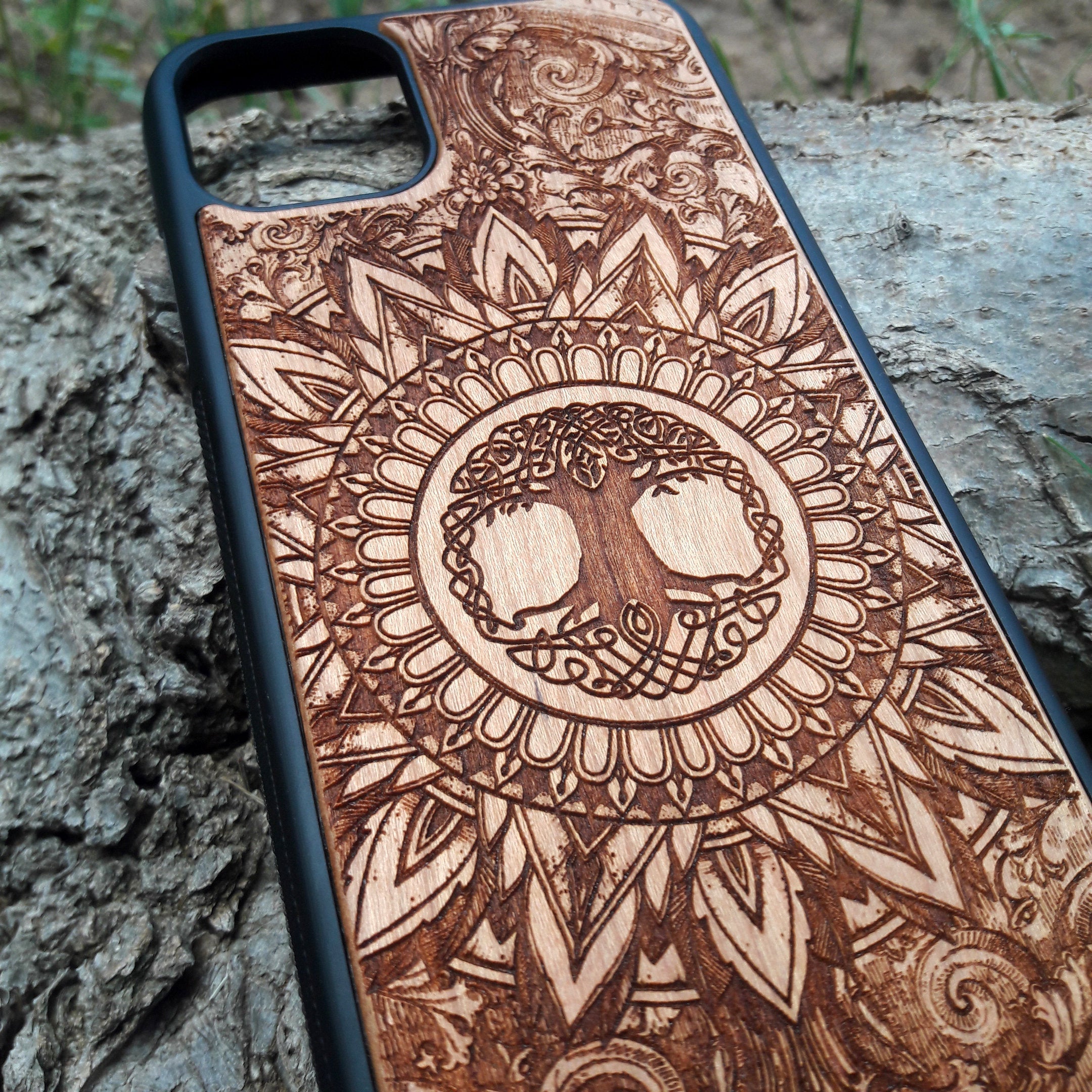 Wooden phone case featuring a detailed, laser-engraved Flower of Life design with intricate mandala patterns. Slim, durable, and compatible with iPhone 16, 15, 14, 13, 12, 11 Pro Max Mini and Samsung Galaxy S25, S24, S23, S22, S21, S20 Ultra Plus, Note 20. Perfect for those who appreciate sacred geometry and natural aesthetics.
