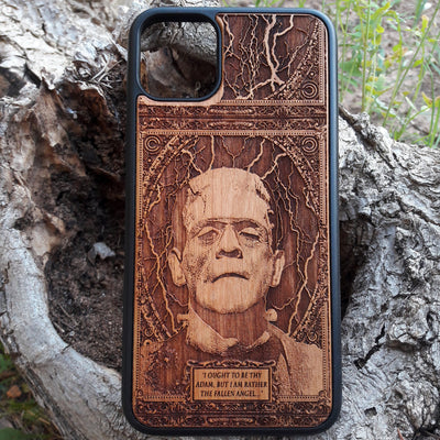 Wooden phone case with intricate carving of Frankenstein’s face and a classic quote: ‘I ought to be thy Adam, but I am rather the fallen angel...’ Designed for iPhone , Samsung Galaxy S. Perfect for classic horror fans and vintage collectors.