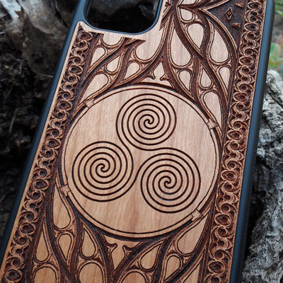 Wooden phone case with a Triskelion Celtic design laser-engraved in a circular pattern, featuring intricate Gothic detailing around the edges. Compatible with iPhone , 15, 14, 13, 12, 11 Pro Max Mini, and Samsung Galaxy S, S24, S23, S22, S21, S20 Ultra Plus, and Note 20. Durable and slim—ideal for lovers of Celtic symbols and unique handcrafted designs.