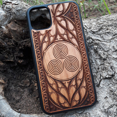 Wooden phone case with a Triskelion Celtic design laser-engraved in a circular pattern, featuring intricate Gothic detailing around the edges. Compatible with iPhone , 15, 14, 13, 12, 11 Pro Max Mini, and Samsung Galaxy S, S24, S23, S22, S21, S20 Ultra Plus, and Note 20. Durable and slim—ideal for lovers of Celtic symbols and unique handcrafted designs.