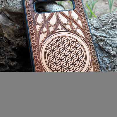 Wooden phone case featuring an intricate laser-engraved Flower of Life design, surrounded by detailed Gothic patterns. Slim, durable, and compatible with iPhone , 15, 14, 13, 12, 11 Pro Max Mini, and Samsung Galaxy S, S24, S23, S22, S21, S20 Ultra Plus, and Note 20. Perfect for those who love sacred geometry and unique craftsmanship.