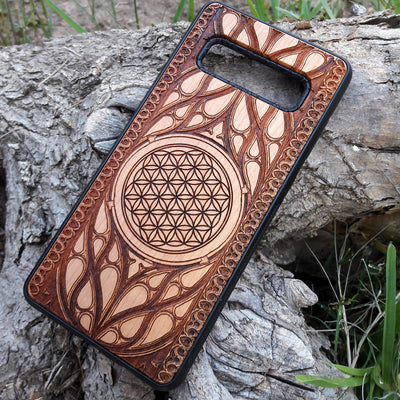 Wooden phone case featuring an intricate laser-engraved Flower of Life design, surrounded by detailed Gothic patterns. Slim, durable, and compatible with iPhone , 15, 14, 13, 12, 11 Pro Max Mini, and Samsung Galaxy S, S24, S23, S22, S21, S20 Ultra Plus, and Note 20. Perfect for those who love sacred geometry and unique craftsmanship.