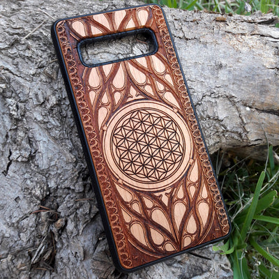Wooden phone case featuring an intricate laser-engraved Flower of Life design, surrounded by detailed Gothic patterns. Slim, durable, and compatible with iPhone , 15, 14, 13, 12, 11 Pro Max Mini, and Samsung Galaxy S, S24, S23, S22, S21, S20 Ultra Plus, and Note 20. Perfect for those who love sacred geometry and unique craftsmanship.