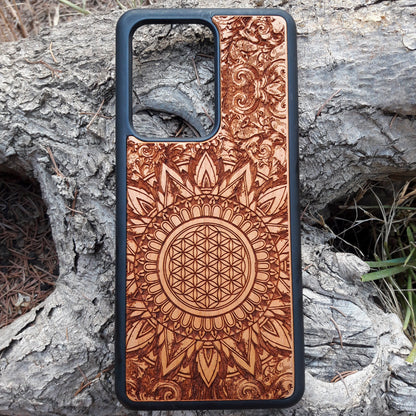 Wooden phone case featuring a detailed, laser-engraved Flower of Life design with intricate mandala patterns. Slim, durable, and compatible with iPhone 16, 15, 14, 13, 12, 11 Pro Max Mini and Samsung Galaxy S25, S24, S23, S22, S21, S20 Ultra Plus, Note 20. Perfect for those who appreciate sacred geometry and natural aesthetics.
