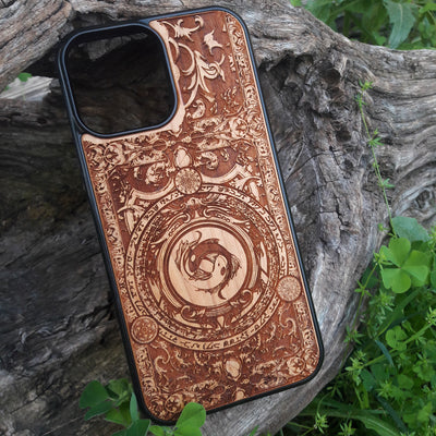 Intricately designed wood phone case featuring a yin-yang koi fish motif surrounded by detailed ornamental patterns and symbolic script. Laser-engraved for precision and durability, this case is compatible with iPhone , 15, 14, 13, 12, 11, Pro Max, Mini, and Samsung Galaxy S, S24, S23, S22, S21, S20 Ultra, Plus, Note 20. A unique and artistic accessory for those seeking elegance and protection.